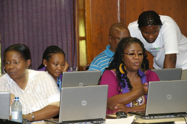 Educators using laptops learning how to author OER.